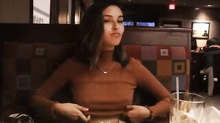 Beautiful girlfriend showing her perfect tits in a restaurant