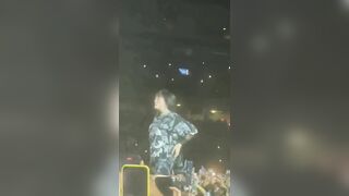 Billie pulling up her leggings on stage